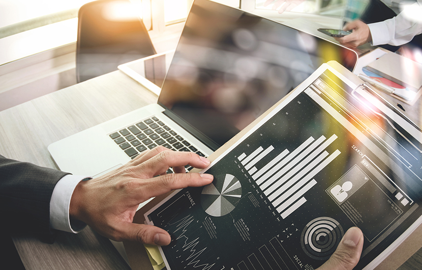 profesional revisando dashboard de analítica con gráficos y métricas en una tablet